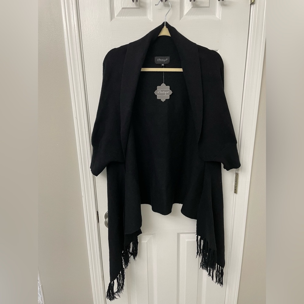 Sweater shrug with tassels